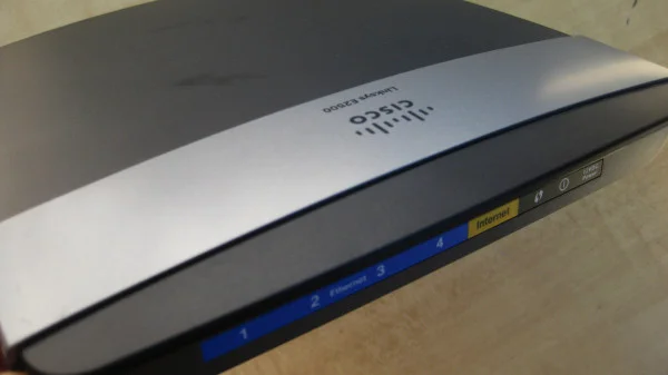 Old Cisco router with multiple Ethernet ports and indicator lights, no longer in use.